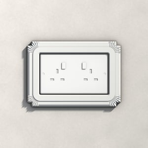 May include: A white double electrical wall socket faceplate featuring a rectangular center and a decorative border with radiating linear grooves at each of the four corners, designed for a standard two-gang electrical socket configuration.