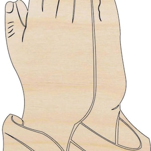 May include: A wooden cutout of hands clasped in prayer. The hands are light brown with black outlines, depicting the fingers and the shape of the hands. The image is a simple, two-dimensional illustration.