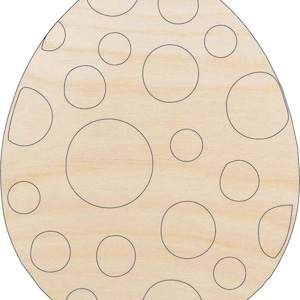 May include: A light-colored wooden cutout in the shape of an egg, featuring a smooth surface with a series of black-outlined circles of varying sizes distributed across the front, creating a dotted pattern on the natural wood grain texture.