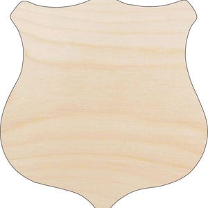 May include: A blank wooden shield shape with a black outline. The shield has a light wood grain pattern and a smooth surface. The shield is ready for painting or decorating.