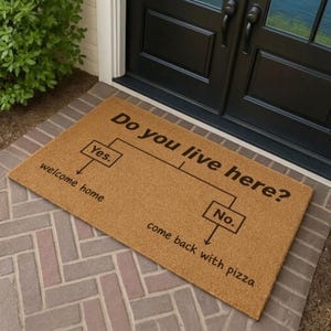 May include: A rectangular tan coir doormat featuring a black printed flowchart with the text Do you live here? followed by two branches. The Yes branch leads to the text welcome home, and the No branch leads to the text come back with pizza.