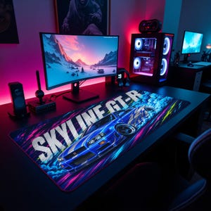 May include: A rectangular desk mat featuring a blue Nissan Skyline GT-R car graphic with motion blur effects, white text reading SKYLINE GT-R, and vibrant pink, purple, and yellow streaks on a black background, positioned on a dark gaming desk.