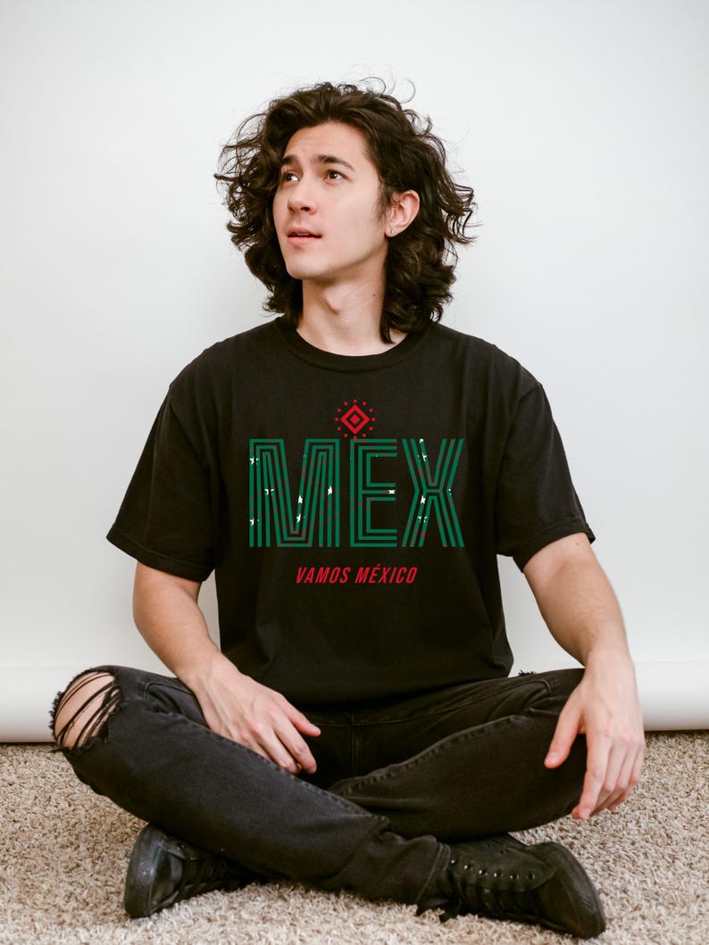 May include: Black t-shirt with the word "MEX" in green, with white accents, and the words "VAMOS M&Eacute;XICO" in red. The shirt has a geometric design above the word "MEX".
