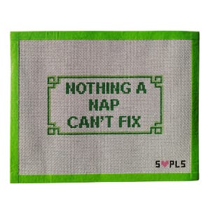 May include: A rectangular needlepoint canvas with a white background and a green border. The text "NOTHING A NAP CAN'T FIX" is displayed in green within a green rectangular frame. The bottom right corner has the text "S ❤️ PLS".