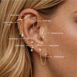 May include: An ear adorned with various gold-colored earrings. The collection includes a chain cuff, star studs, a bow, and a curved design with dangling elements. The earrings are displayed on a person's ear, showcasing the different styles.