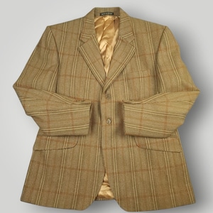 May include: A tan plaid blazer with a gold satin lining. The blazer has two front pockets and buttoned cuffs. The jacket is a classic style, suitable for formal or business attire.