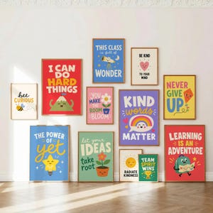 May include: A collection of eleven colourful wall art prints featuring motivational phrases and cartoon illustrations including a bee, a mountain, a telescope, a flower, a rainbow, a star, a sun, and a backpack, all displayed in wooden frames.