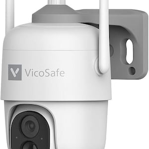 May include: White VicoSafe security camera with two antennas and a gray mounting bracket. The camera has a black lens and the VicoSafe logo is visible on the front. The camera is designed for outdoor use.