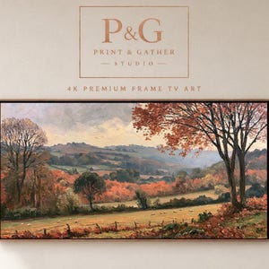 May include: A rectangular landscape painting in a thin wooden frame featuring an autumn scene with orange and red trees, rolling hills, and a grassy field. The text P&G PRINT & GATHER STUDIO 4K PREMIUM FRAME TV ART is displayed above the artwork.