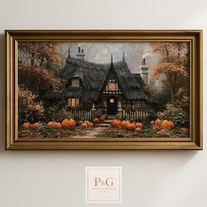 May include: A framed landscape painting depicting a dark, thatched-roof cottage surrounded by autumn trees and numerous orange pumpkins. The scene features a white picket fence, glowing windows, and a chimney with smoke, all encased in a gold frame.