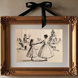 May include: A framed black and white line drawing print featuring a scene with a nutcracker and figures dancing in a room with a Christmas tree. The artwork is enclosed in an ornate gold-colored frame with a black ribbon bow at the top.