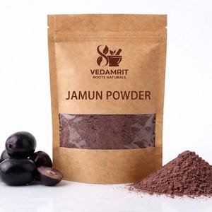 May include: A brown paper bag of Jamun Powder with a clear window, a pile of dark purple Jamun berries, and a small pile of brown powder. The bag has the text "VEDAMRIT ROOTS NATURALS" and "JAMUN POWDER".