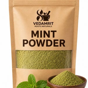 May include: A brown paper pouch containing mint powder with a clear window showing the green contents. The label features the text VEDAMRIT ROOTS NATURALS and MINT POWDER. A small wooden bowl filled with mint powder and fresh mint leaves sit in front.