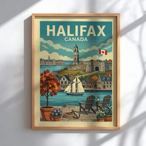 May include: A framed travel poster featuring the text HALIFAX CANADA. The illustration depicts a harbour scene with a sailing boat, the Halifax clock tower, a stone fortress, and a Canadian flag. In the foreground, two wooden chairs sit on a stone patio.
