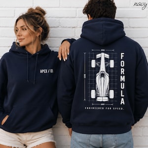 May include: A navy blue hoodie featuring a white graphic on the front chest with the text APEX / 01. The back displays a white technical blueprint of a race car with the text FORMULA and ENGINEERED FOR SPEED, including grid lines and numbers.