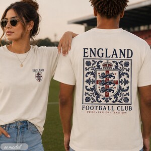 A close-up shot of a woman and man wearing off-white England football club t-shirts outdoors.