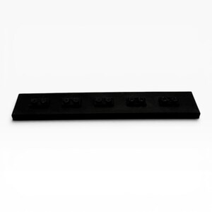 May include: A rectangular black plastic building block base plate featuring five distinct two-stud connection points arranged in a single horizontal row across the surface. The object is solid black with a matte finish and a flat, elongated design.