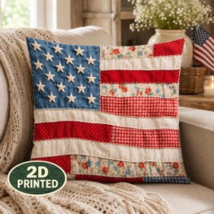 May include: A square throw pillow featuring a 2D printed American flag design. The blue canton displays white stars, while the stripes consist of alternating red, white, and floral-patterned fabric sections with visible stitched detailing.