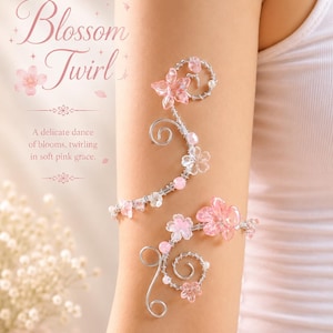 May include: A delicate arm cuff with a floral design. The cuff features pink blossoms and clear beads on a silver wire frame. The text reads "Blossom Twirl" and "A delicate dance of blooms, twirling in soft pink grace."