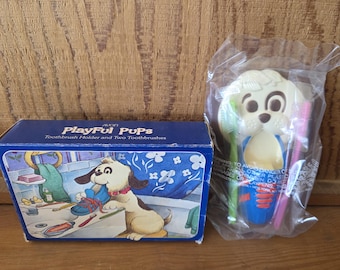 Set vintage Avon del 1981 con portaspazzolini a forma di cuccioli e due spazzolini (sigillato).