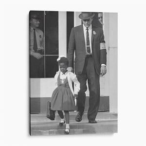 May include: A black and white photograph showing a young child in a dress and cardigan walking down steps next to an adult wearing a suit, tie, and a hat. The adult wears an armband with the text U.S. MARSHAL. A second adult in a uniform stands behind.
