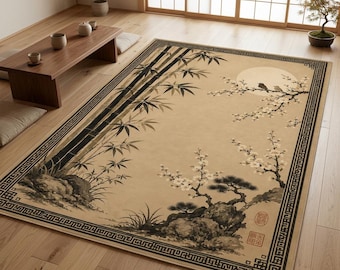 May include: A rectangular area rug featuring a beige background with a black and white ink-wash style illustration of bamboo stalks, a flowering tree branch with two birds, a full moon, and rocks, enclosed by a geometric black border pattern.
