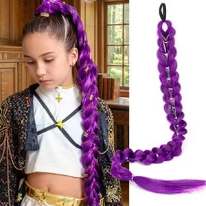 May include: A long, braided purple hair extension with gold accents. The extension is attached to a black elastic band. The braid is decorated with small gold-colored metal pieces. The hairpiece is designed to be worn as a ponytail.