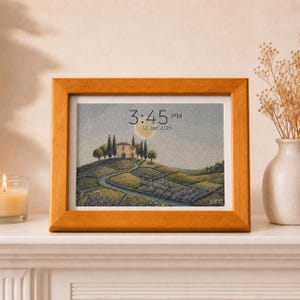 May include: A rectangular wooden frame containing a digital print of a landscape with a house on a hill, cypress trees, and a full moon. The print displays the time 3:45 PM and the date 12 Jan 2026 in black text centered at the top.