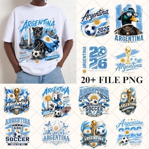 May include: A white t-shirt featuring a graphic of a black panther draped in an Argentina flag with a football, surrounded by various Argentina-themed football designs including ducks, horses, trophies, and the text Argentina 2026 World Cup.