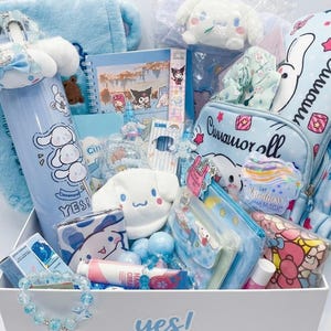 May include: A gift box filled with light blue themed items featuring Cinnamoroll characters, including a tall water bottle with the text YES!, a spiral notebook, a plush toy, a backpack, a beaded bracelet, hand cream, and various stationery accessories.