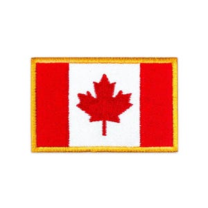May include: A rectangular embroidered patch featuring the Canadian flag design. The patch has a central white vertical stripe with a red maple leaf, flanked by two red vertical stripes. The entire design is bordered by a thick gold thread edge.