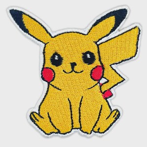 May include: An embroidered patch featuring a yellow creature with long ears tipped in black, round red cheeks, and a lightning bolt-shaped tail. The design includes black eyes, a small nose, and a simple mouth, all outlined in white thread.