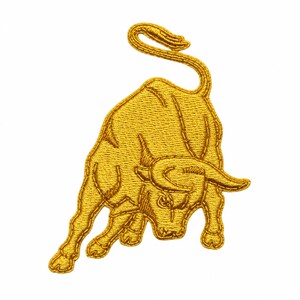 May include: A gold-colored embroidered patch featuring a charging bull in a dynamic, aggressive stance. The design is rendered with detailed stitching that outlines the muscular form, horns, and tail of the animal, creating a textured appearance.