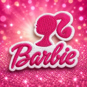 May include: A hot pink embroidered patch featuring the Barbie logo in a cursive script font positioned below a stylized silhouette of a ponytail hairstyle, all outlined with a white border against a bright pink glittery background.