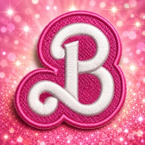 May include: A circular embroidered patch featuring a stylized white letter B with a thick, textured border in vibrant hot pink. The stitching is dense and uniform, creating a raised effect on the surface of the patch, which is set against a bright pink background.