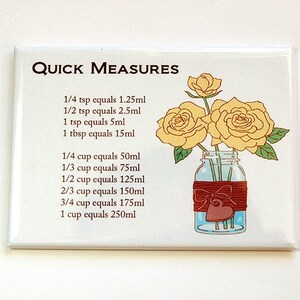 May include: A rectangular magnet with the text "QUICK MEASURES" and conversion charts for teaspoons, tablespoons, and cups to millilitres. The magnet also features a drawing of yellow roses in a glass jar with a red ribbon.
