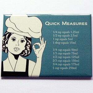 May include: A rectangular kitchen magnet with a teal background and the words "Quick Measures." It features a retro illustration of a chef giving an "okay" hand gesture. Measurements are listed in millilitres.