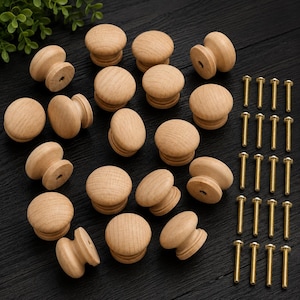 May include: A collection of unfinished wooden cabinet knobs with a rounded top and a cylindrical base. The knobs are accompanied by a set of brass screws, perfect for furniture restoration or new builds.