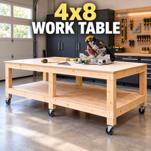 May include: A large rectangular wooden work table with a light natural finish, featuring a lower storage shelf and four heavy-duty caster wheels. The surface displays the text 4x8 WORK TABLE, a miter saw, a measuring tape, and a square tool.