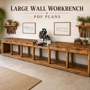 Puede incluir: Un banco de trabajo de pared grande de madera con múltiples cajones y un estante inferior abierto. El texto LARGE WALL WORKBENCH PDF PLANS aparece arriba. Dos dibujos técnicos enmarcados cuelgan en la pared, flanqueados por paneles perforados.
