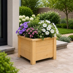 May include: A wooden planter box filled with vibrant flowers. The box is made of light-colored wood and is filled with a variety of colorful flowers, including purple, pink, and white blooms. The planter is outdoors, likely in a garden setting.