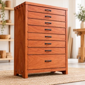 May include: A tall wooden chest of drawers featuring a warm reddish-brown wood grain finish. The unit includes eight horizontal drawers, each equipped with a small, dark metal handle. The frame displays visible joinery details at the corners.