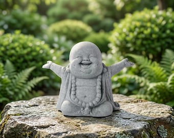 May include: A gray stone statue of a laughing figure with a round face and bald head, depicted in a seated position with arms outstretched. The figure wears a beaded necklace and simple robes, featuring a textured, weathered stone surface finish.