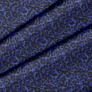 Può includere: Un tessuto caratterizzato da un motivo leopardato ripetuto in tonalità blu reale intenso e nero. Il materiale presenta un disegno coerente di macchie animali su tutta la superficie, con pieghe che creano ombre diagonali che ne esaltano la trama.
