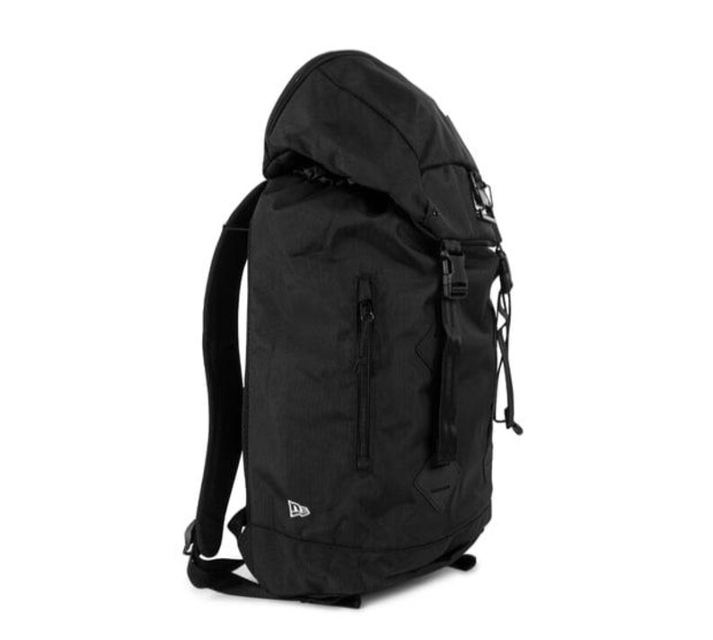 May include: Black backpack with a roll-top closure, side straps, and a front zippered pocket. The backpack has adjustable shoulder straps and a top handle. The New Era logo is visible on the lower front. The bag is made of a durable, textured material.