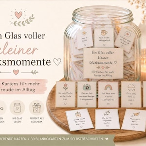 Puede incluir: Un frasco de vidrio lleno de peque&ntilde;as tarjetas, cada una con una ilustraci&oacute;n &uacute;nica y texto en alem&aacute;n. La etiqueta del frasco dice "Ein Glas voller kleiner Gl&uuml;cksmomente" con 150 tarjetas para la alegr&iacute;a diaria. Varias tarjetas individuales est&aacute;n frente al frasco.