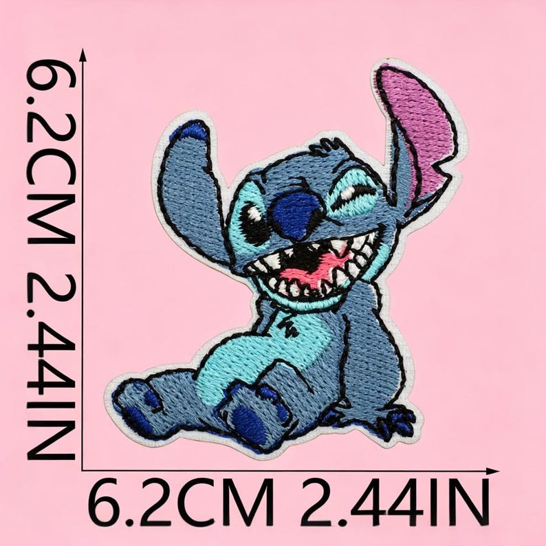 May include: An embroidered patch of the blue alien character Stitch, featuring a wide grin, large ears with pink inner details, and dark blue nose. The patch measures 6.2 cm by 6.2 cm, which is equivalent to 2.44 inches by 2.44 inches as indicated.
