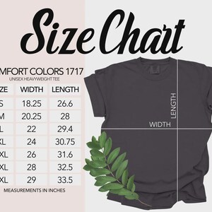May include: A dark gray Comfort Colors 1717 unisex heavyweight tee shirt with a size chart. The size chart shows measurements in inches for sizes S through 4XL. The shirt has a folded sleeve and a sprig of green leaves.