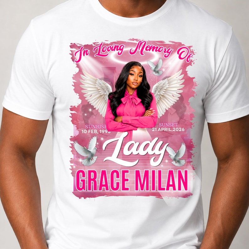 May include: A white t-shirt featuring a memorial graphic with the text In Loving Memory Of, Lady, and GRACE MILAN. The design includes a portrait of a person with angel wings, a halo, white doves, and the dates Sunrise 10 FEB, 1995 and Sunset 21 APRIL, 2026.
