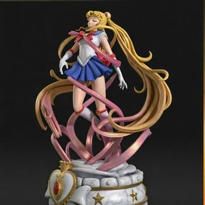 May include: A detailed figurine of a character with long blonde hair, wearing a sailor-style outfit in white and blue, with pink accents. The figure is posed dynamically, with flowing hair and ribbons, atop a decorative base with gold stars and a heart-shaped emblem. The word "TURNTABLE" is at the top.